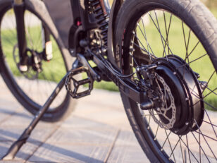 Electric bike motor wheel close up with pedal and rear shock absorber